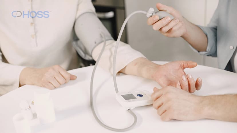 Patient having their blood pressure checked at home as part of chronic disease management.