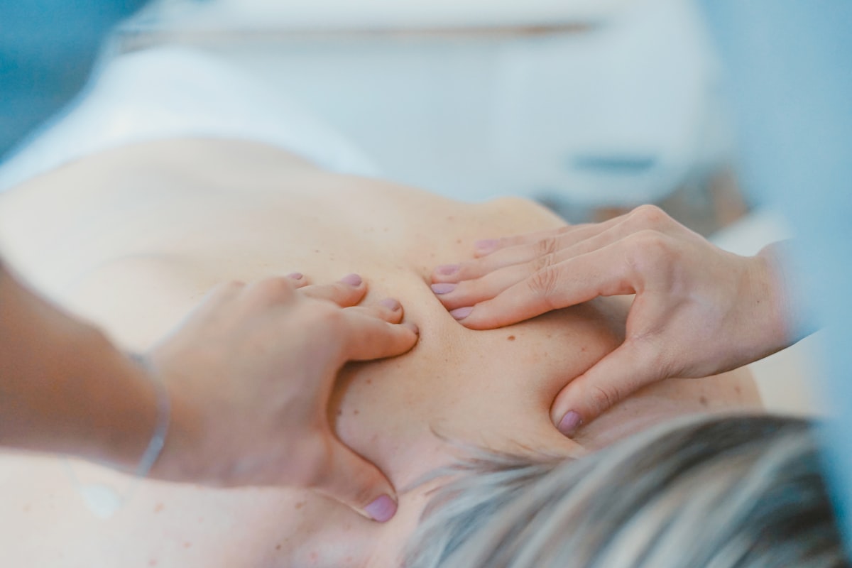 Chiropractor performing spinal adjustment on patient